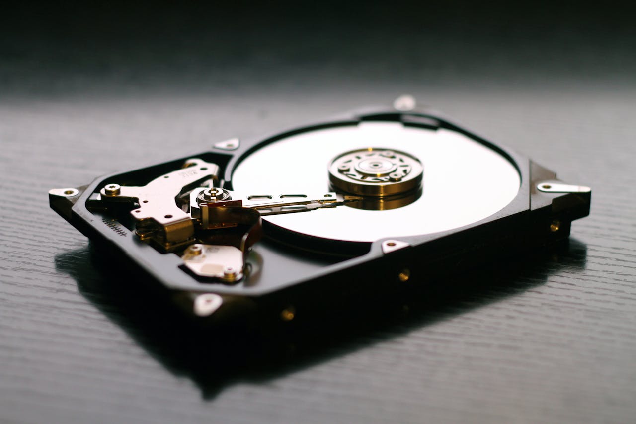 Mastering the First Impression: Your intriguing post title goes here An open hard drive is displayed on a wooden surface, showcasing its internal components and metallic details.
